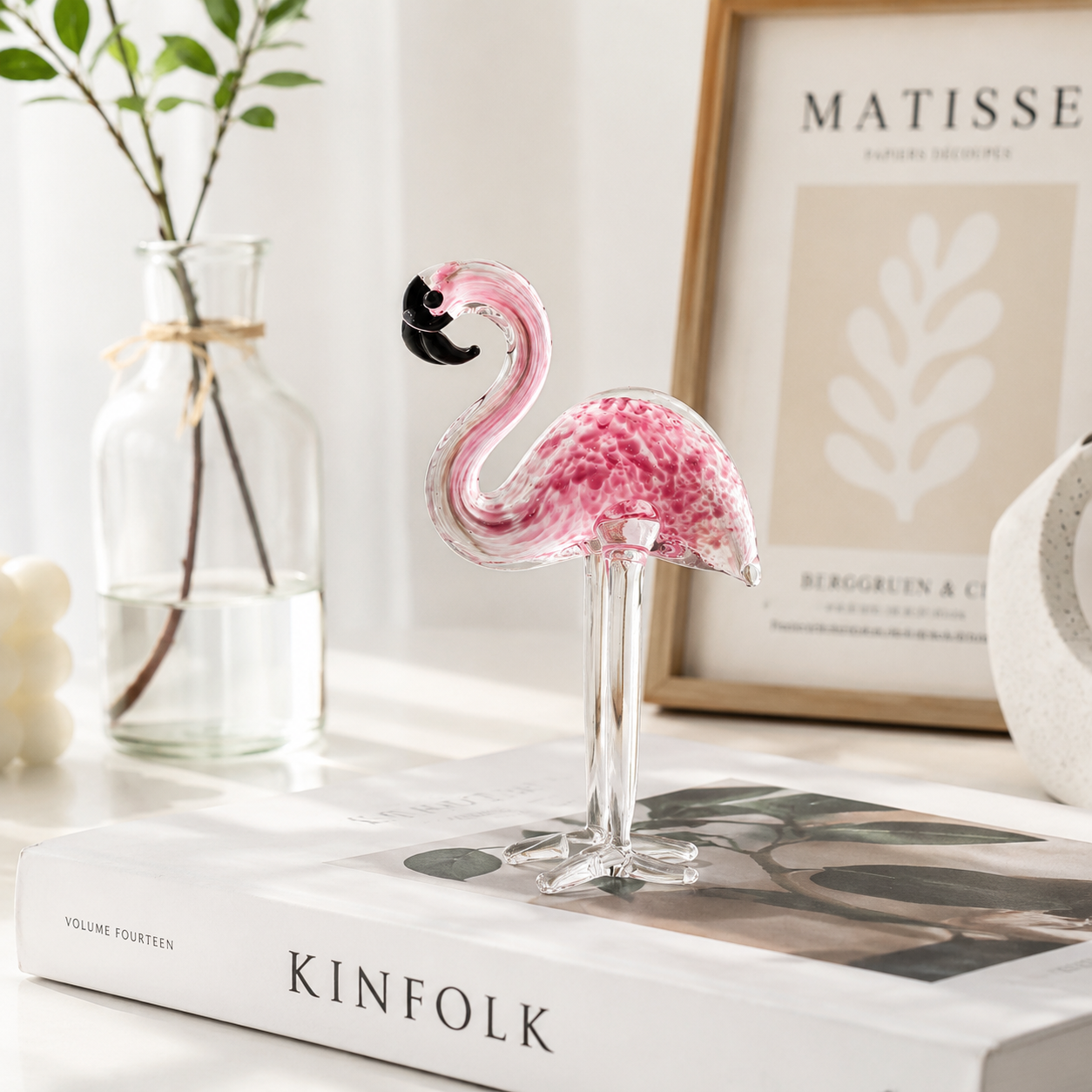 Pink and red glass flamingo desktop decor styled on luxury home shelf