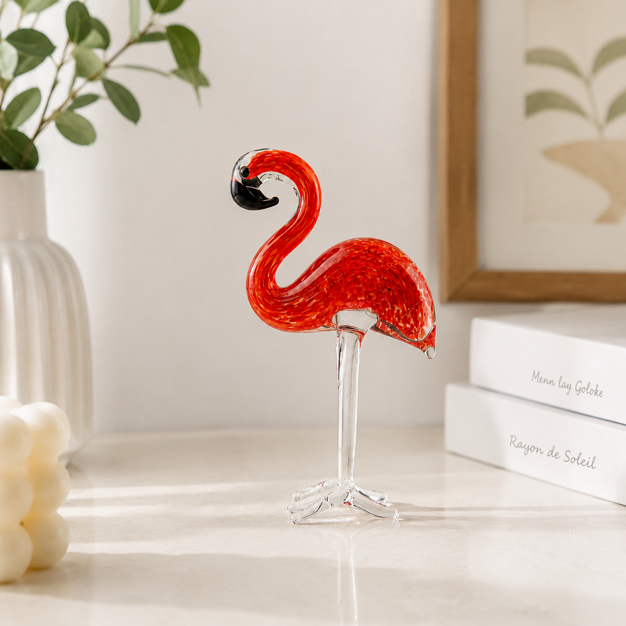 Pink and red glass flamingo desktop decor styled on luxury home shelf