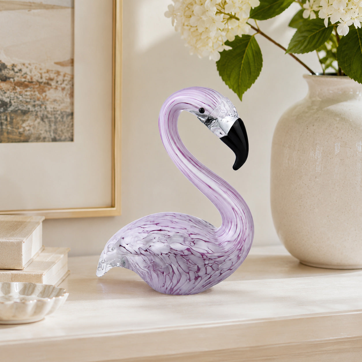Purple glass flamingo desktop decor styled on luxury home office shelf
